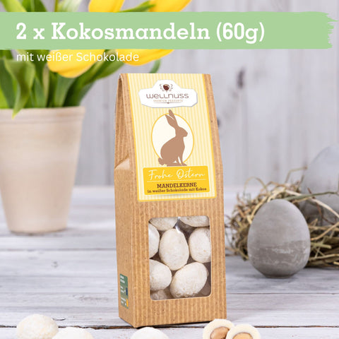 Osterbundle mit 2x Kokosmandeln (60g) in weißer Schokolade. Festliche Verpackung mit Osterhasenmotiv, ideal für genussvolle Ostertage.