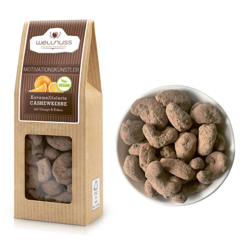 Motivationskünstler - Karamellisierte Cashewkerne mit Orange & Kakao in 60 g Packung von Wellnuss. Knusprige Cashews mit fruchtiger Orangennote und Kakaopulver.